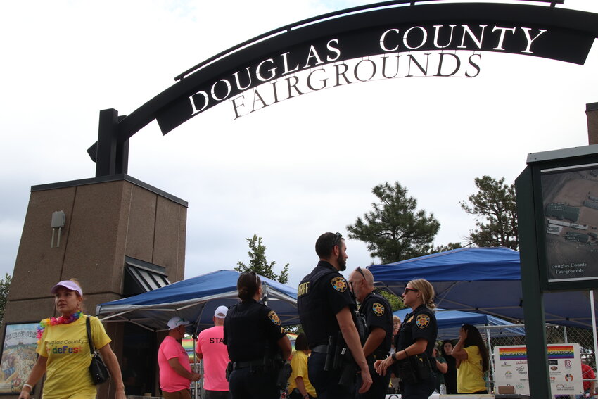 Law enforcement personnel stand near the gate at the Douglas County Fairgrounds Aug. 26 during PrideFest.